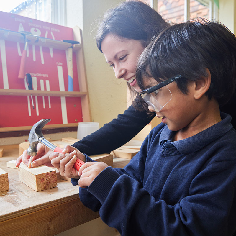 photo of a student and teacher doing woodwork